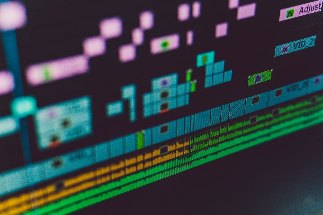 Close-up of a video editing timeline on screen with multiple clips arranged in sequence