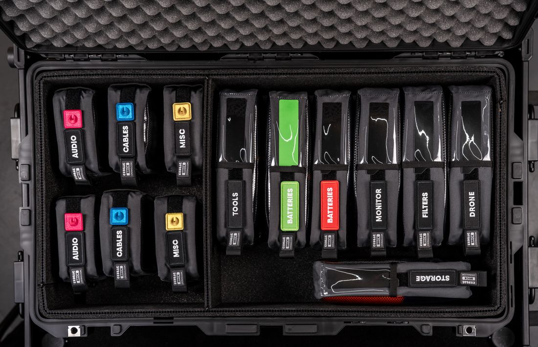A hard case of camera and production equipment neatly organized and labeled for travel