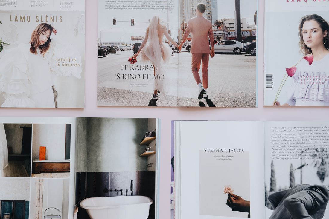 Open magazine spreads laid out on a table, the kind of layout a press portrait has to fit into
