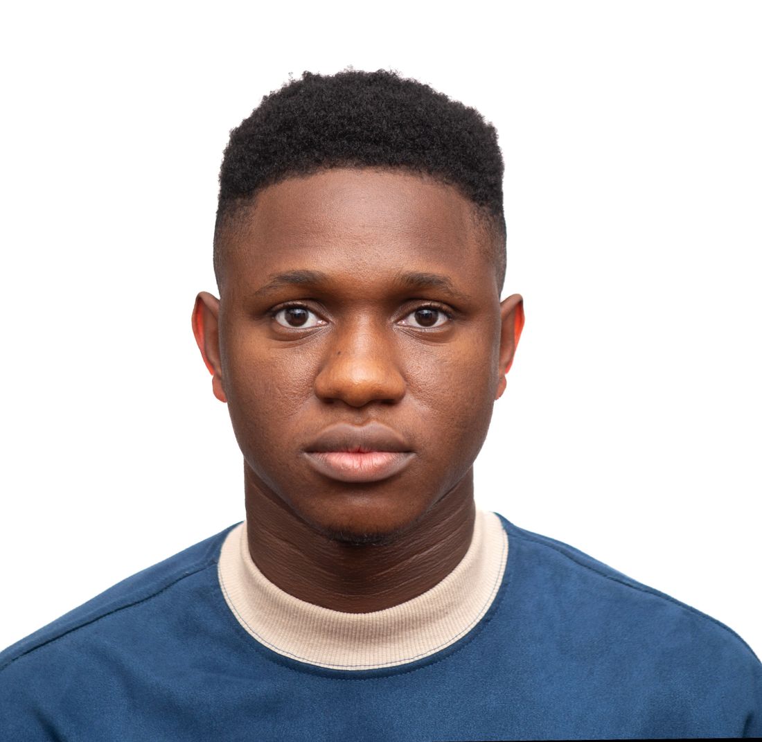 Close-up portrait of a person with a neutral, direct expression against a plain white background