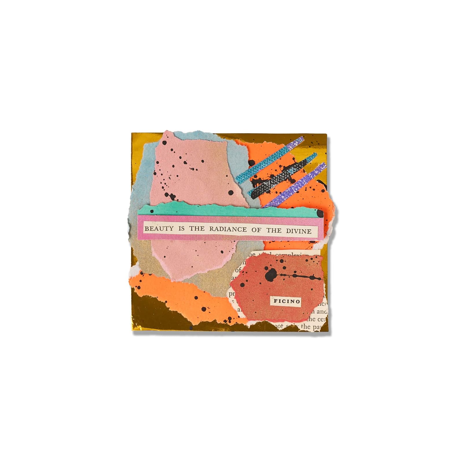 A small paper collage reading Beauty Is The Radiance Of The Divine on ink-splattered torn paper