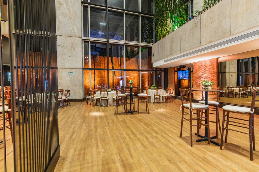 A formal, elegant hall set with small tables and chairs, empty before a reception