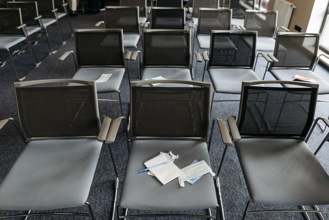Rows of empty modern conference room chairs arranged for a corporate event