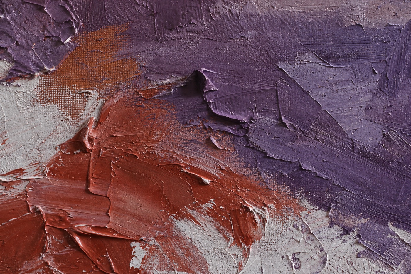 Artwork detail with thick violet, red, and cream impasto photographed under soft side light
