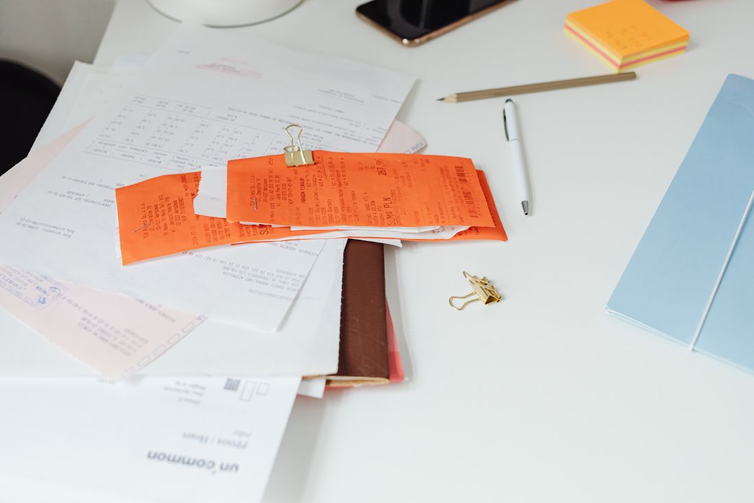A flat lay of paperwork and documents on a desk, representing the certificate of insurance a landmarked building often requires