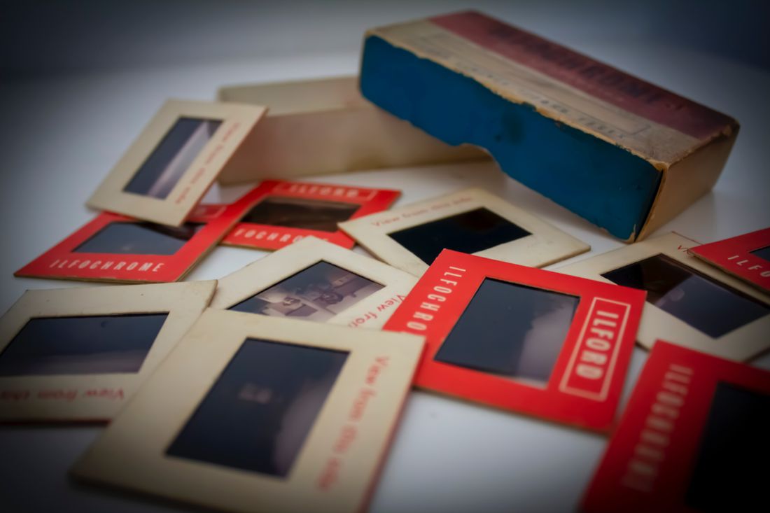 A collection of framed Polaroid-style photographs spread out together, evoking a personal photo archive