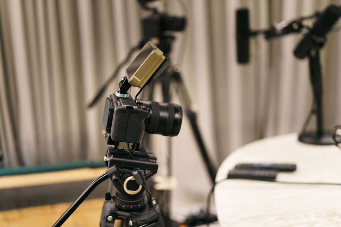 A camera mounted on a tripod facing into a quiet room, framed and left in position