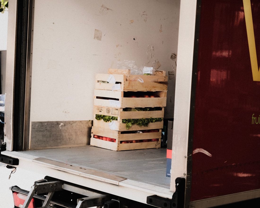 Wooden crates stacked against a wall in a gallery loading area during an install