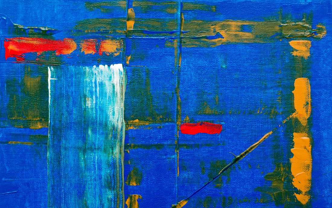 A close-up of a saturated blue, red, and gold abstract acrylic painting on canvas